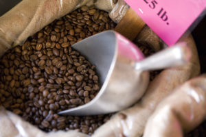 Scooping coffee beans from bag